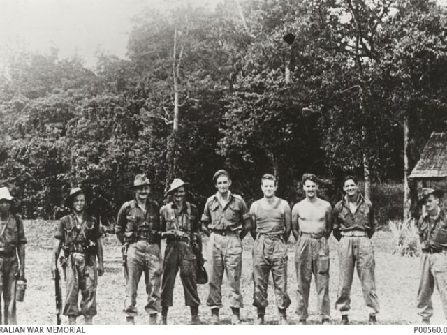 Informal group portrait of members of the Semut II team at Long Akar, Borneo. This team undertook missions behind Japanese lines. Identified left to right: WX36796 Lance Sergeant (later reverts to corporal) Abu Kassim Bin Marah; WX36793 Sergeant (Sgt) Teh Soen Hin; VB325894 Captain (later Major, Semut III) William Lomas Philip Sochon, British Army; Sgt T. Barrie; QX48608 Major Gordon Senior "Toby" Carter; NX164342 Sgt Charles Walter Pare; TX16283 Sgt Kelvin Walter Hallam; believed to be Dan Illerich USAAF; 