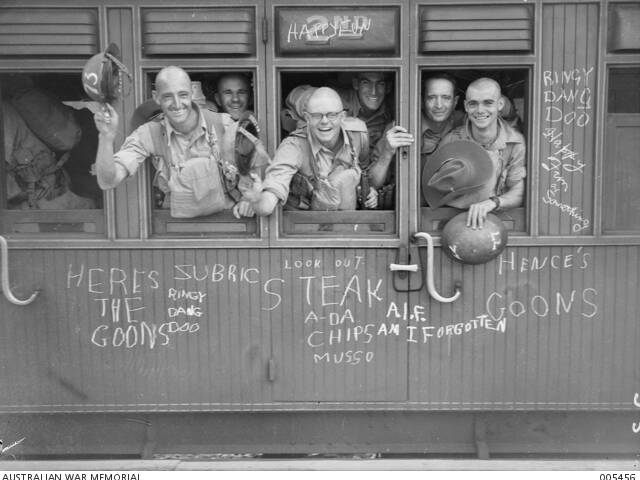Train carriage with chalked graffiti on the outside of the carriage including reference to 'Hence's Goons'