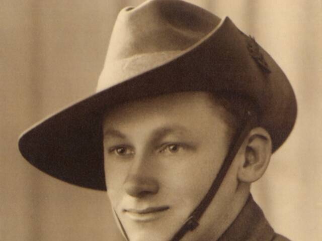 Studio portrait of Private QX7976 Hector Alexander McIntyre, 2/26 Battalion, of Cairns, Qld AWM P08973.00.