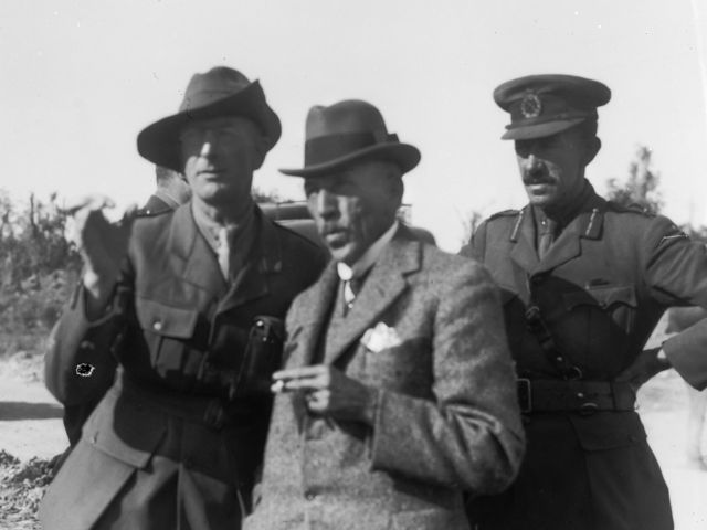 Mr C E W Bean, Australian Official Correspondent (left), the Right Honourable W. M. Hughes, Prime Minister of Australia (centre), and Brigadier General H. A. Goddard DSO, General Officer Commanding, 9th Infantry Brigade (right), at Mont St Quentin.